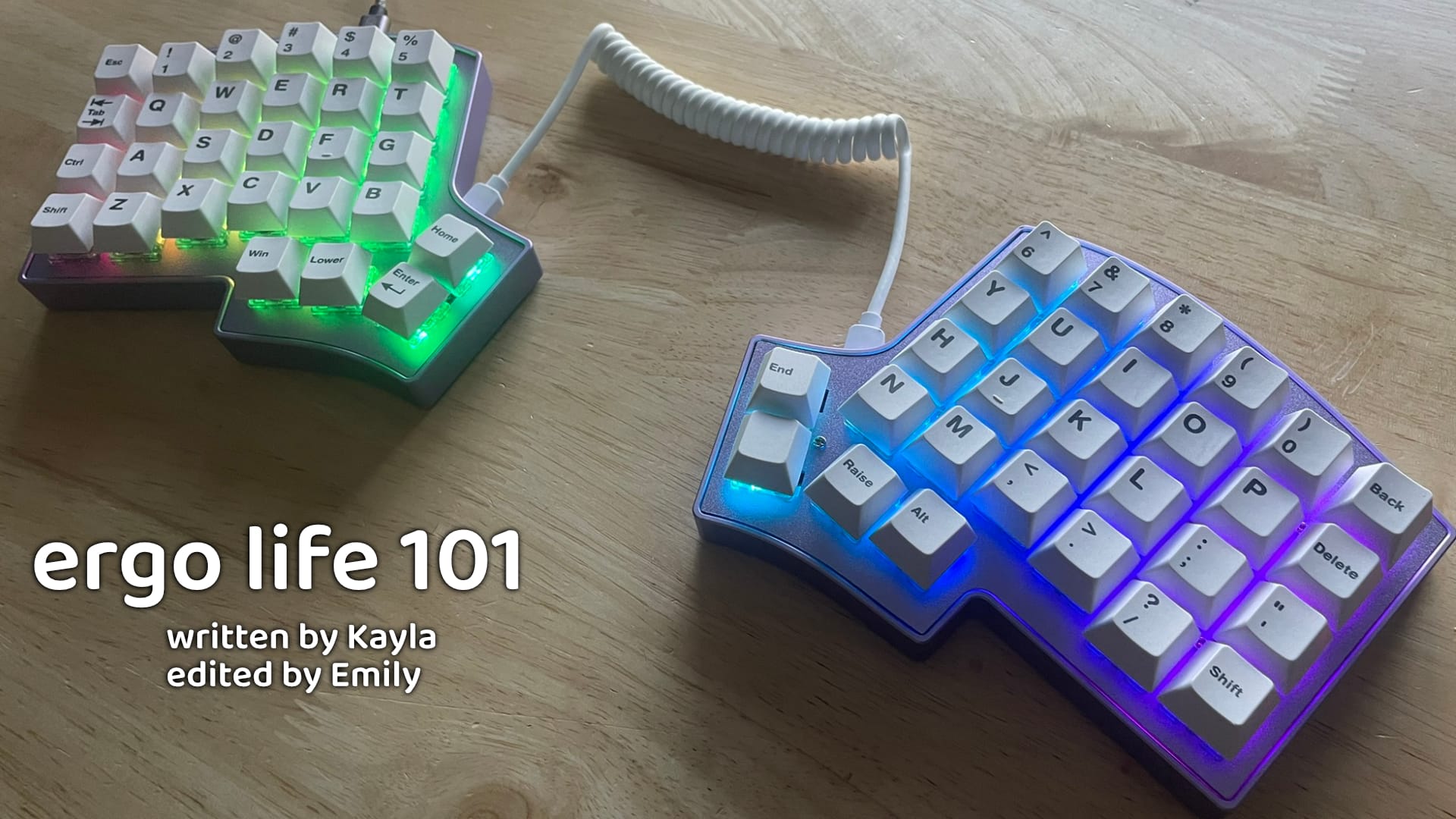 A Lilac Iris SE illuminated with per-key RGB, with the words "ergo life 101" and "written by Kayla", "edited by Emily"